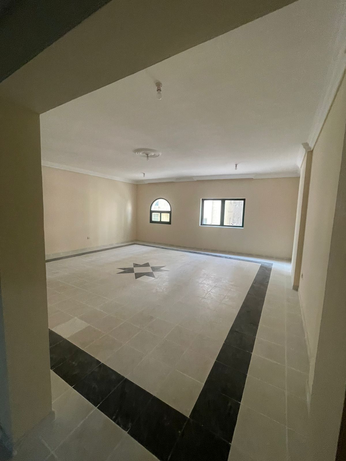 For rent in Al Qasimia / Al Mahatta, a very spacious 3-bedroom apartment with hall, 3 bathrooms, a large kitchen, and central AC, located in a prime a