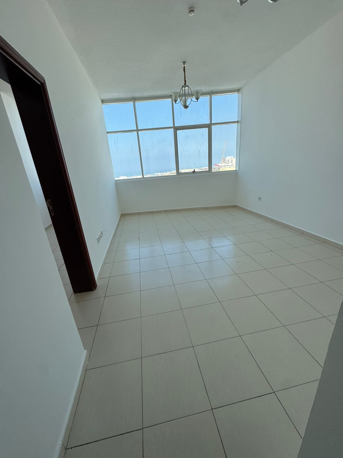 For annual rent in Sharjah, specifically in Al Majaz 3 area: a one-bedroom apartment with a living room, central air conditioning, and an excellent si
