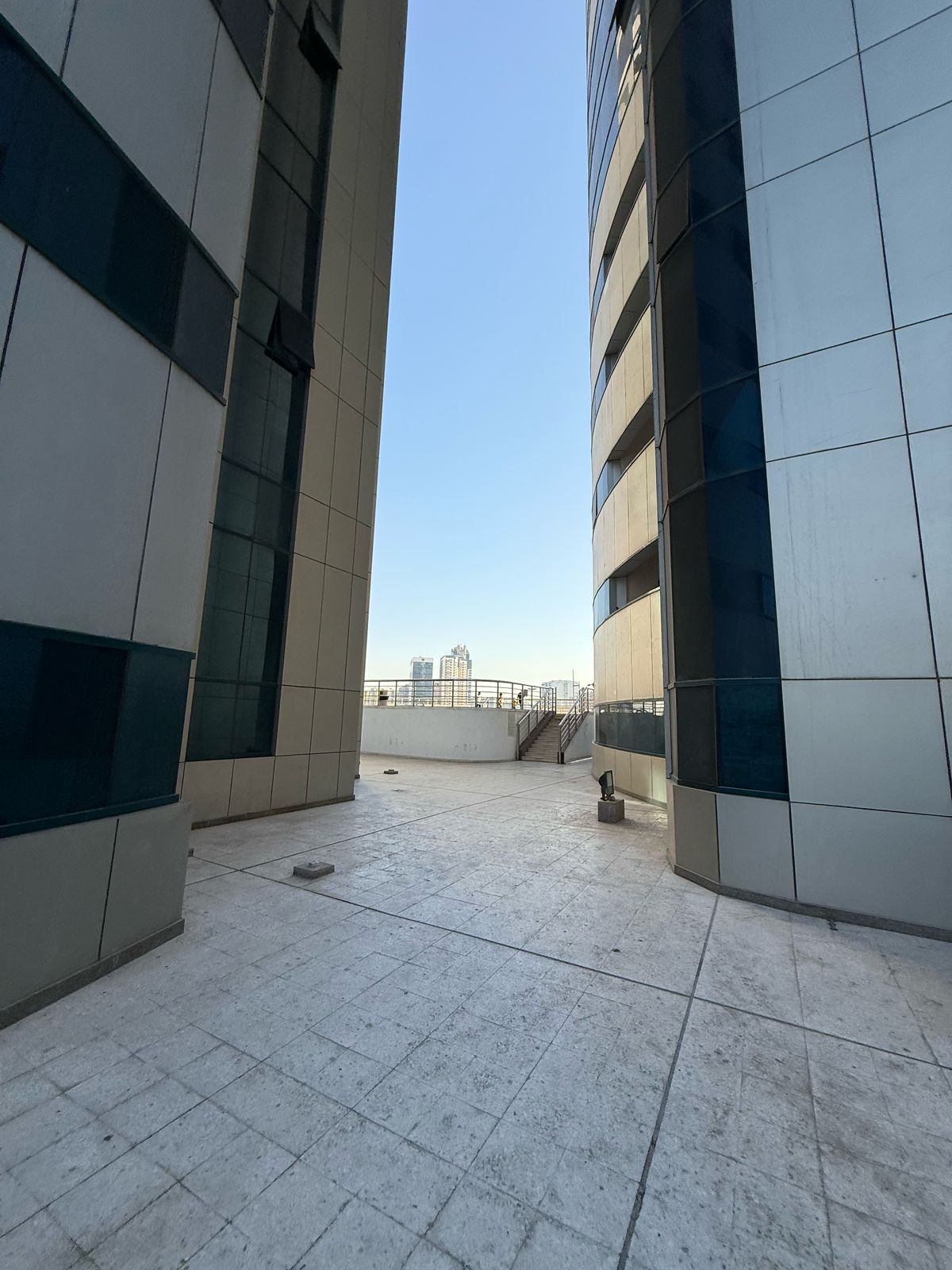 For annual rent in Sharjah, specifically in the Al Taawun area: a one-bedroom apartment with a living room, two bathrooms, and central air conditionin
