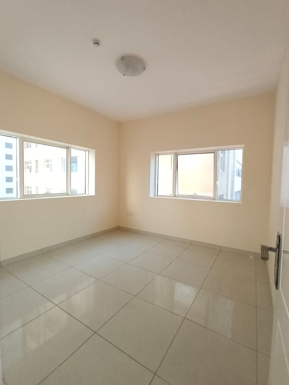 For annual rent in Sharjah, specifically in Al Khan area: two bedrooms, a living room, central air conditioning, and an excellent size.