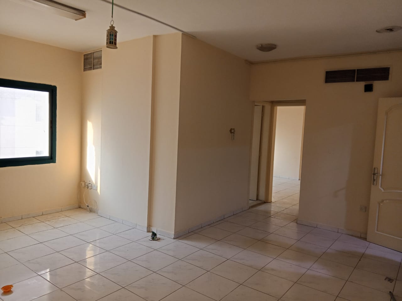 For annual rent in Sharjah, specifically in the Al Qasimia area: a one-bedroom apartment with a living room, central air conditioning, and excellent s