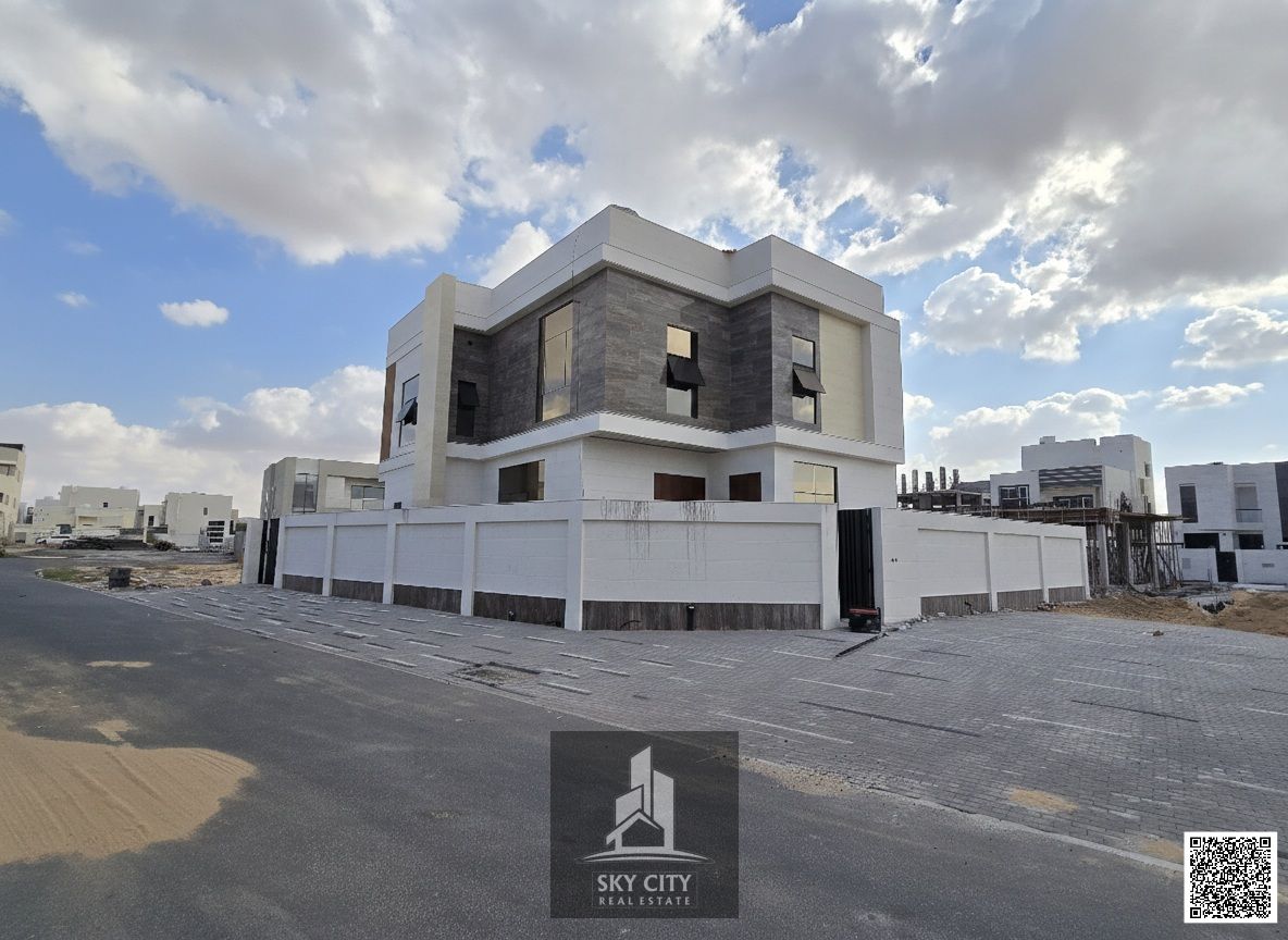 Hotel villa, corner of two streets in Al Zahia area, personal finishing, central air conditioning, next to a mall and close to Emirates Bypass Road, freehold ownership for all nationalities without fees.