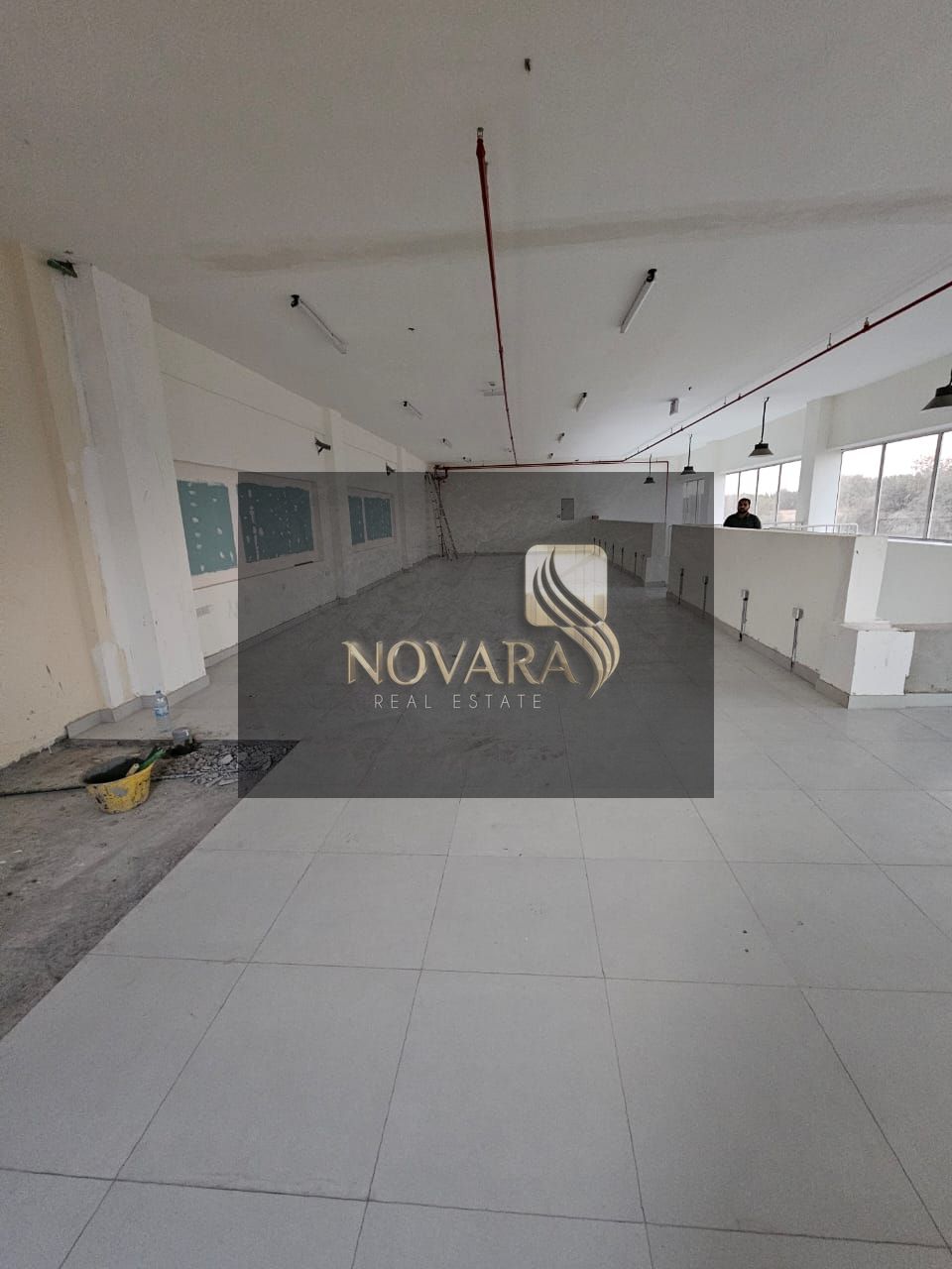 Warehouse for rent in Al Bahia Ajman, area 3,250 square feet with mezzanine, electricity 32 kilowatts, vital location, rent 165,000 dirhams annually.