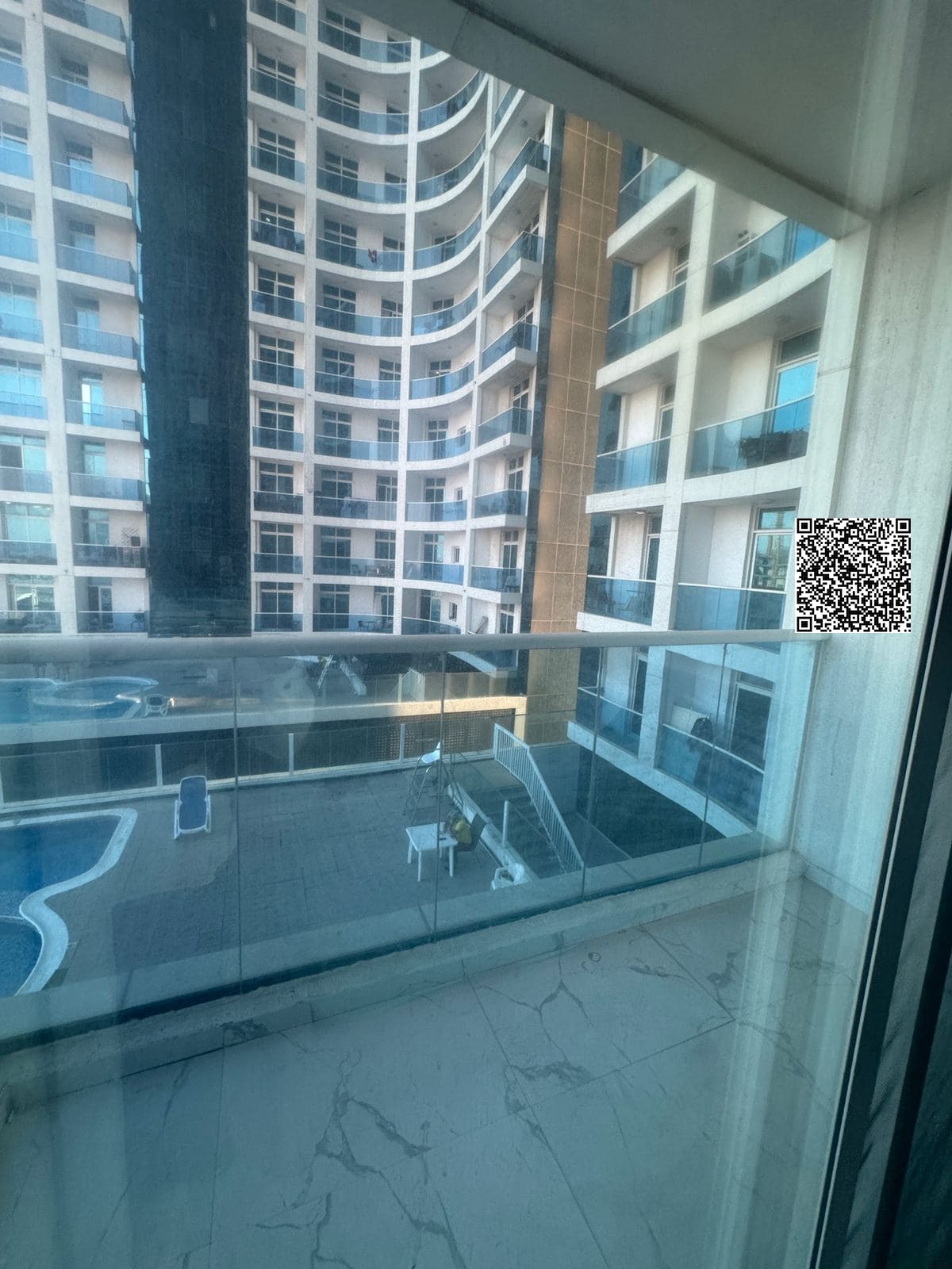 Two bedrooms and a living room with a balcony and parking
