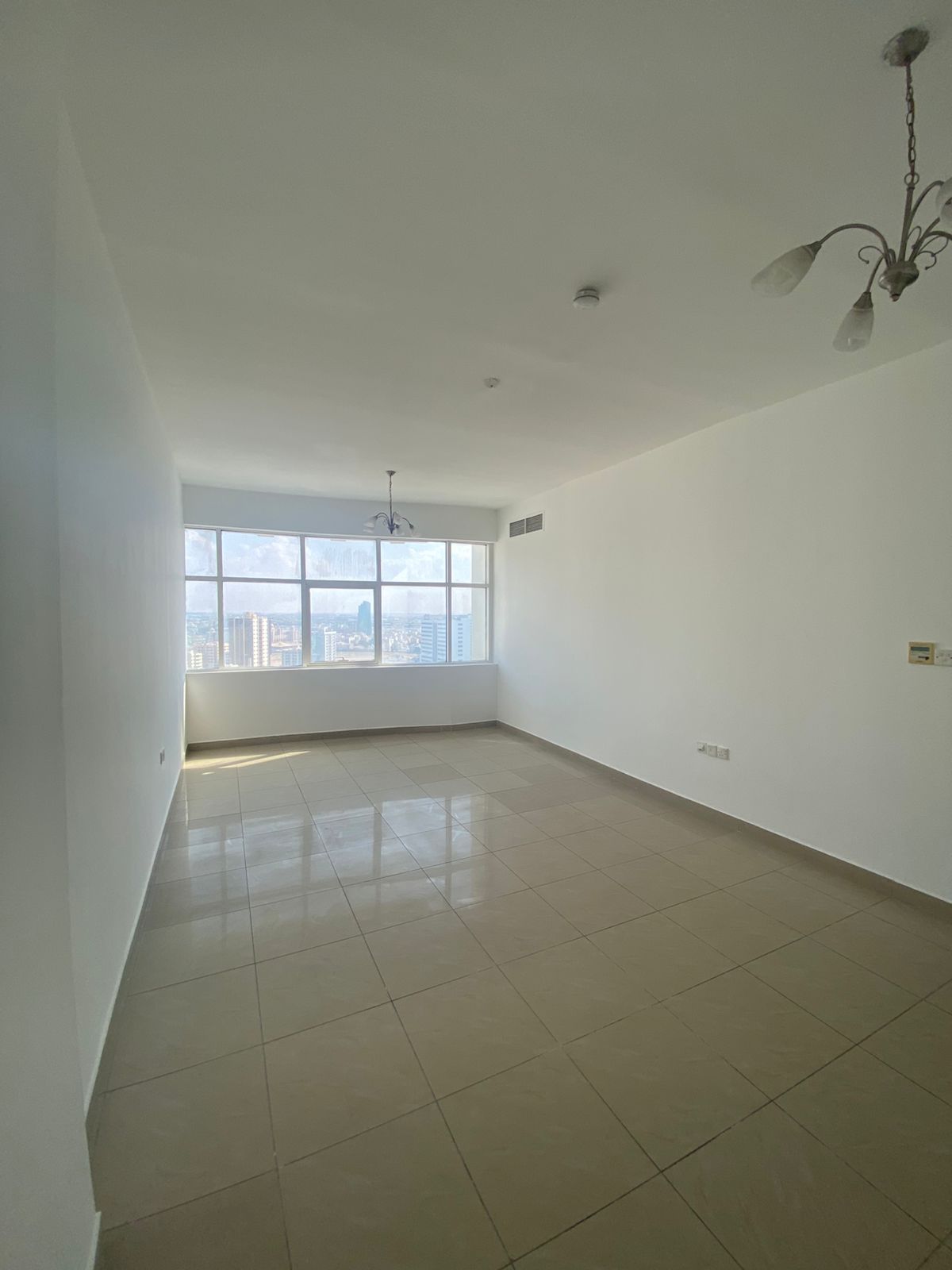 2-bedroom apartment with living room and laundry room in a clean family building, located in Al Majarah on a main road with a mall underneath.