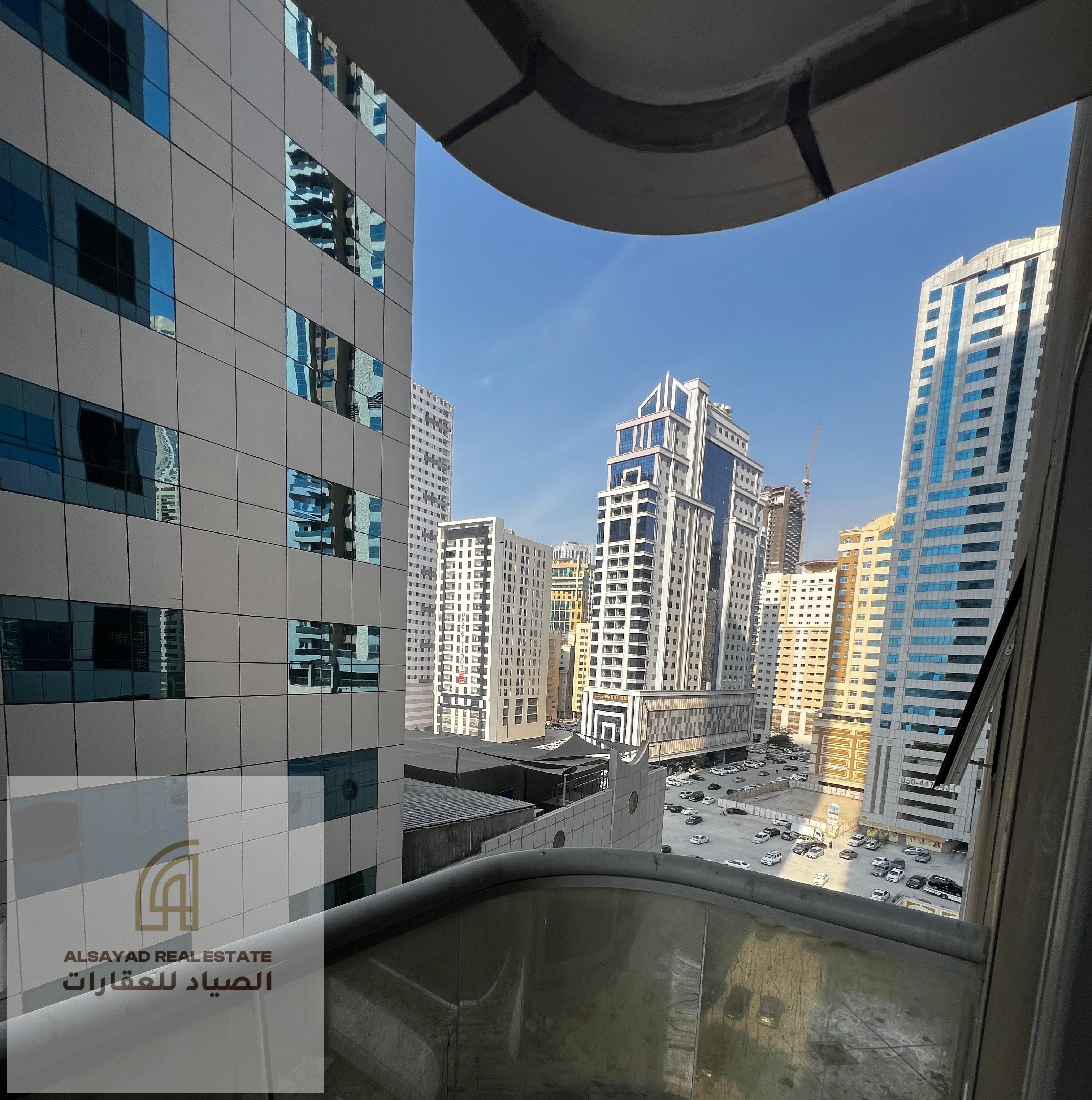 Two-bedroom apartment with a living room in Al Khan area, Sharjah, featuring a sea view and a private parking space