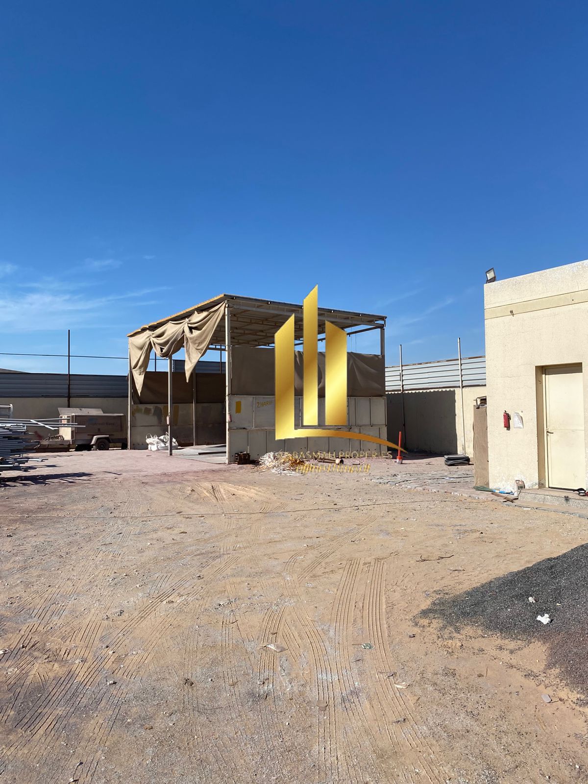 For sale in the Al Sajaa Industrial area: a built land with an office + kitchen + bathroom, with an electrical capacity of 25 watts, covering an area
