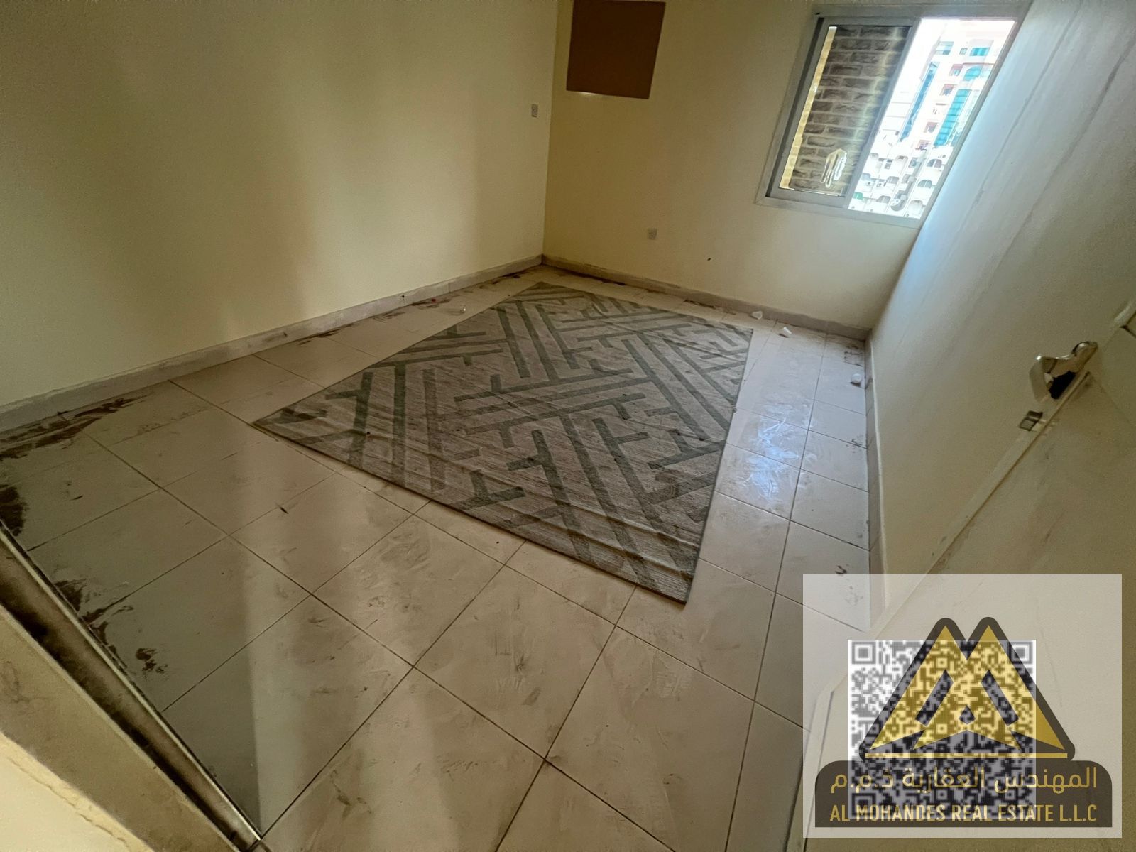 Available for rent in Al Rumaila, Ajman: a two-bedroom apartment with a living room, offering practical features at an affordable price.
