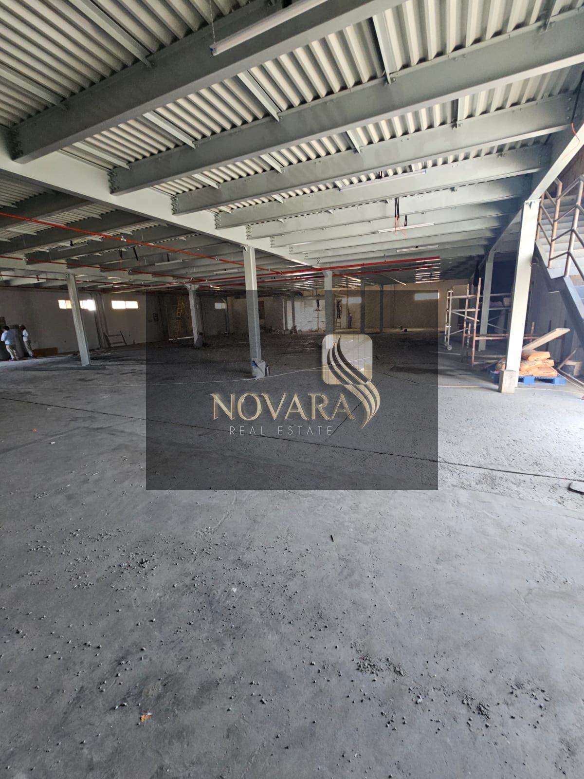 A prime warehouse in a strategic location on the main street, suitable for various industrial and commercial activities, with an area of 15,000 squa