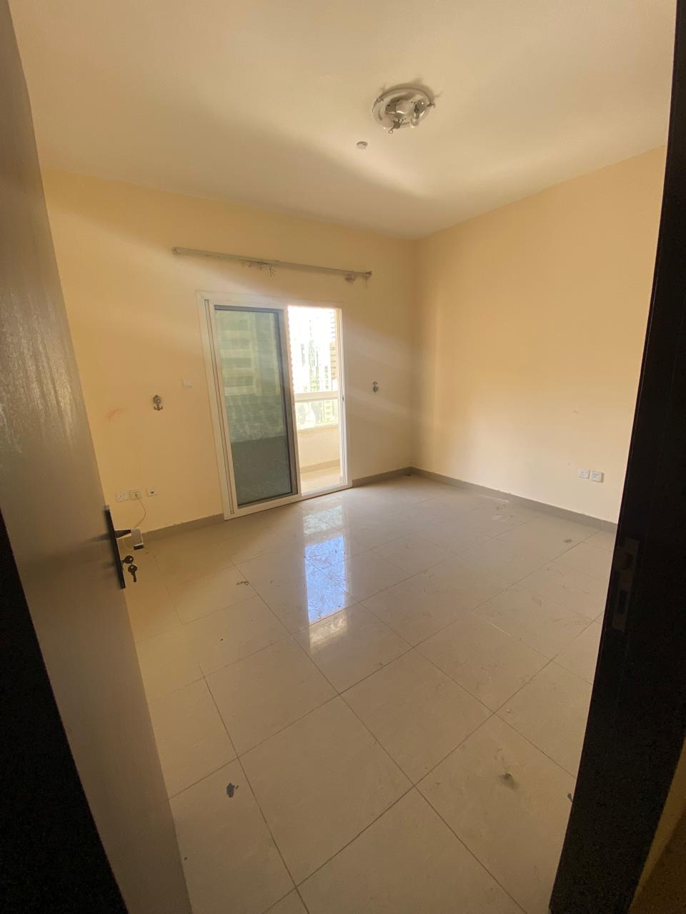 For annual rent in Sharjah, specifically in the Al Taawun area: two bedrooms, a living room, two bathrooms, a balcony, central air conditioning, and a
