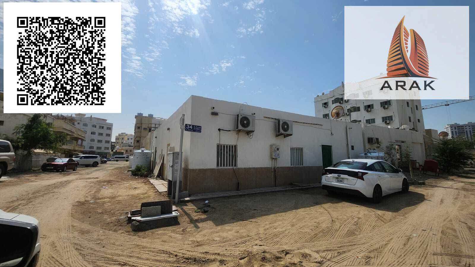For Sale: Traditional House in Al Bustan – Ajman A traditional house for sale in Al Bustan, Ajman, located on a prime corner plot facing two streets.