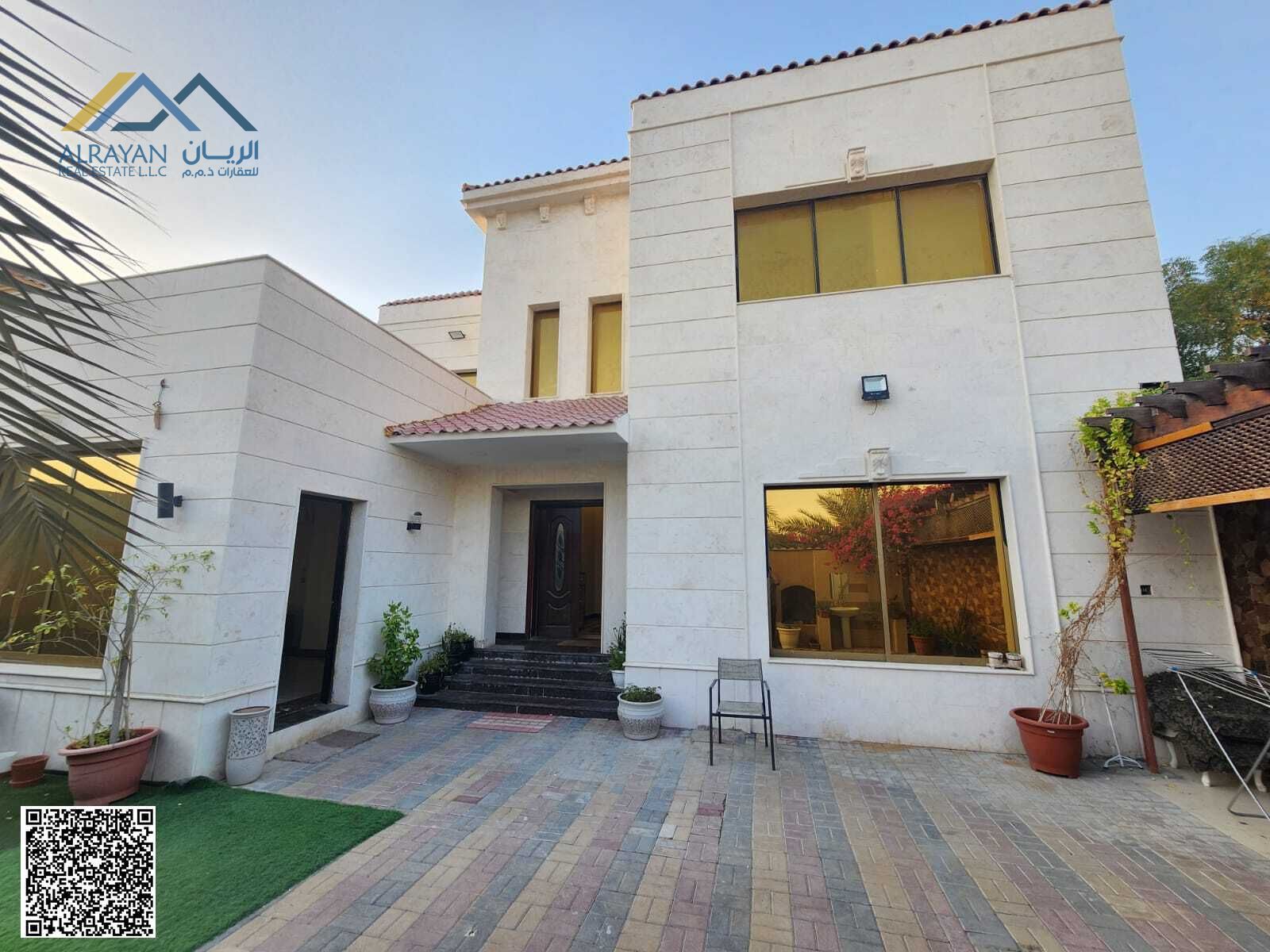 Luxury corner villa for sale in Al Rawda 1, opposite the mosque, with an external annex. Price includes electricity, air conditioning, and water.