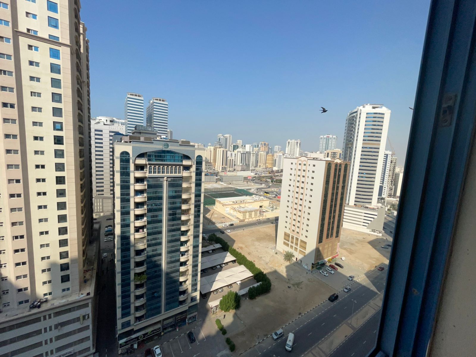 Two-bedroom apartment with balcony in Al Nahda Sharjah, open view, two bathrooms, multiple units available, close to Dubai exit.