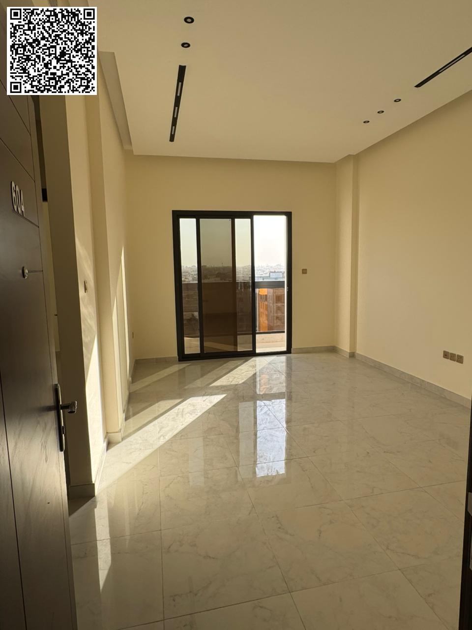 For annual rent in Ajman, a brand new building in Al Jurf 3, first occupancy. Two bedrooms, a living room, three bathrooms, a balcony with an open vie