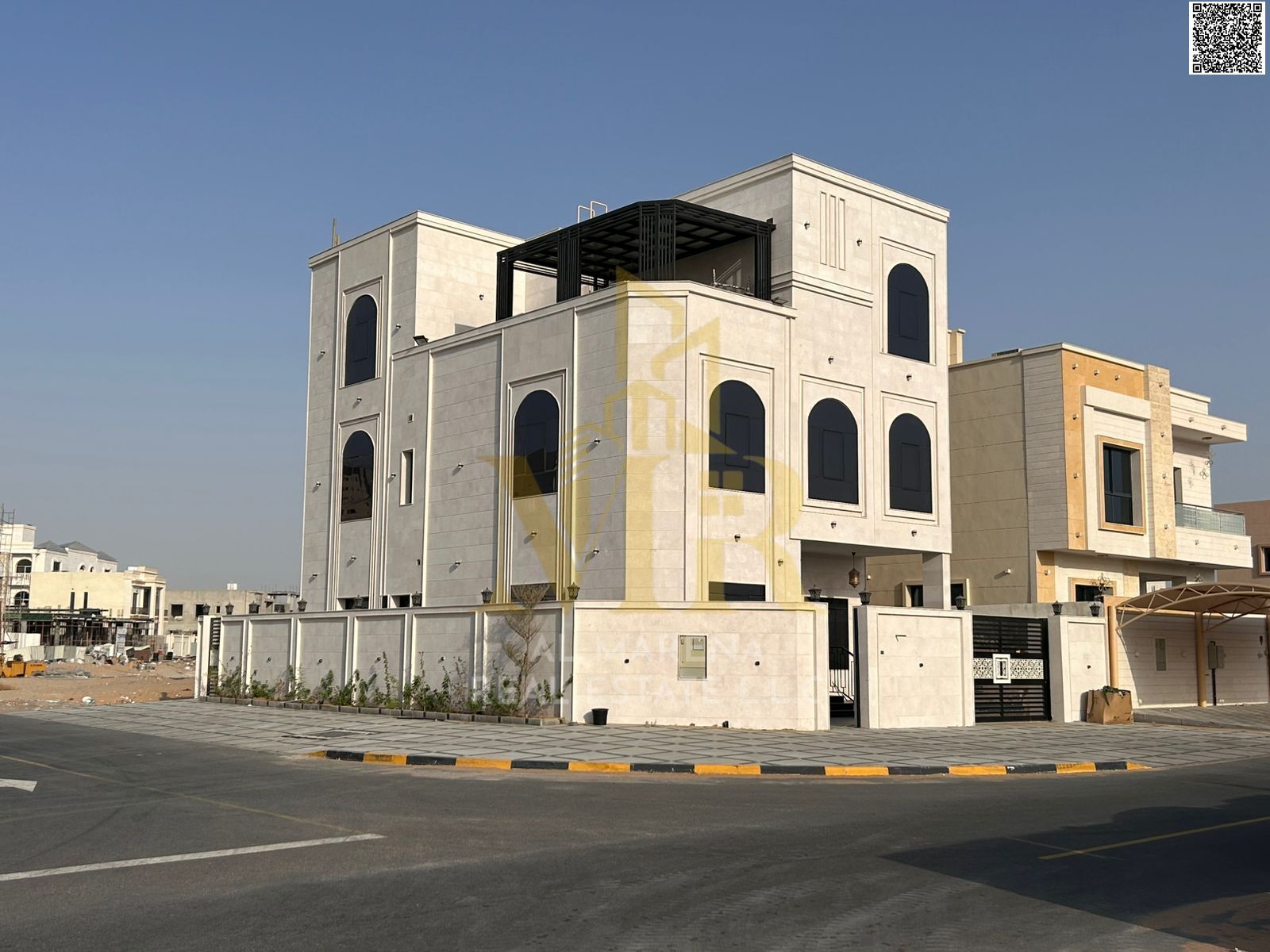 Luxury modern corner villa with a stone facade, 7 bedrooms (ground floor, first floor, and roof), located in Al Amerah area, Ajman. Registration fees