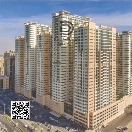 Own a 2-bedroom apartment with living room in Ajman One Towers, prime strategic location, high floor with stunning sea view, modern layout close to al