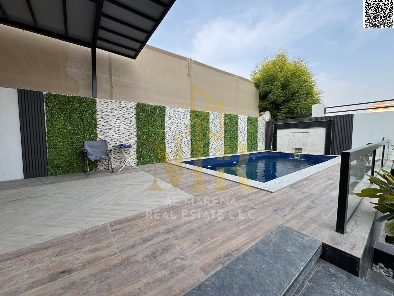 Luxury villa for sale in Al Muwaihat 2, Ajman, with a swimming pool. Price includes electricity, water, and air conditioning. Freehold ownership.