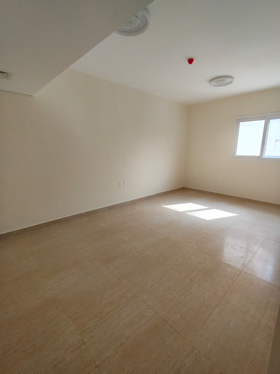 First-occupancy one-bedroom apartment with living room, modern design, ideal for a small family, near Sharjah Municipality and all services