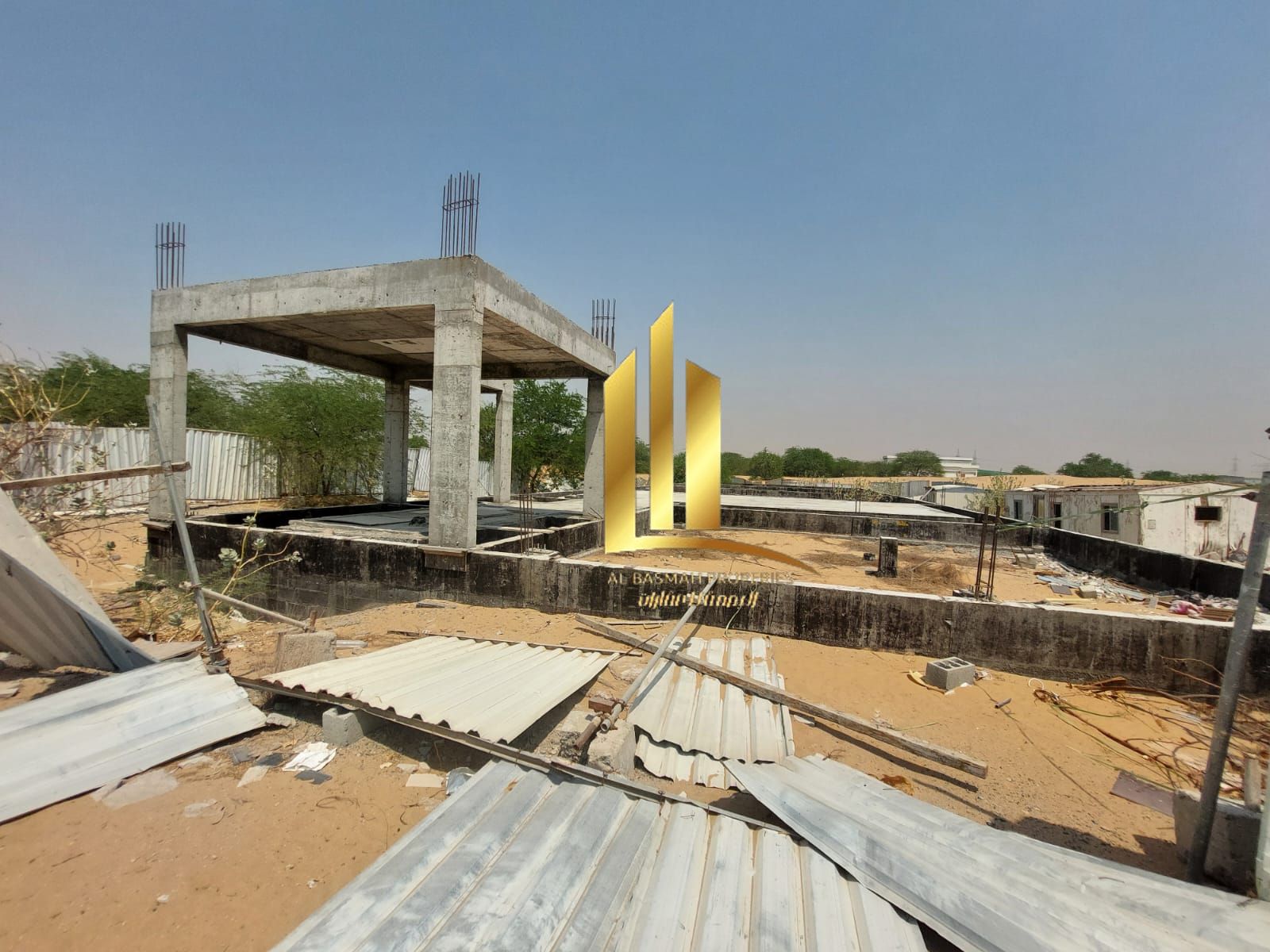 Industrial land for sale in Arqoub, Sharjah, equipped with foundations for building 10 warehouses.