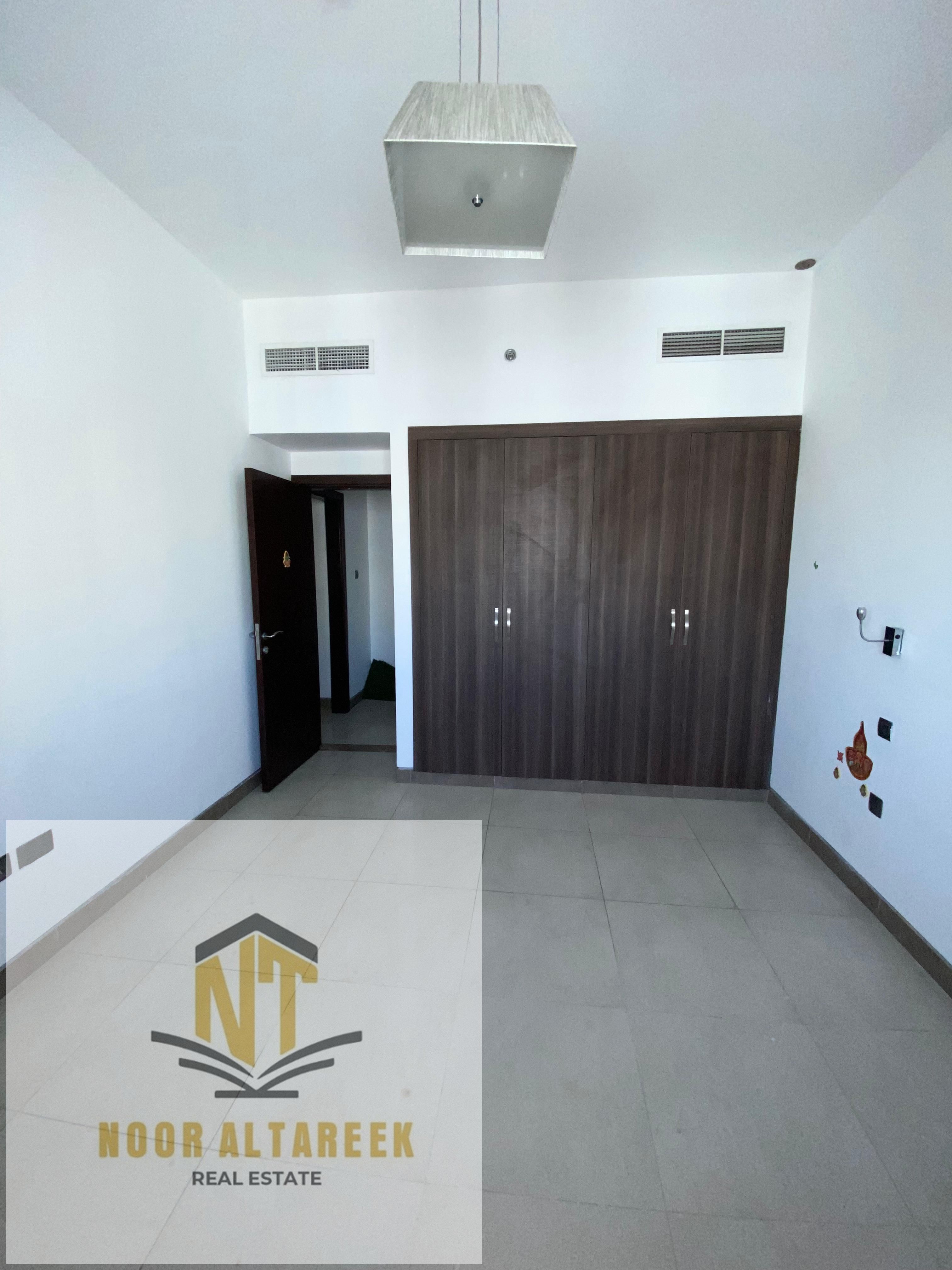 Apartment for rent in Al Qasimia, one room, a hall, a bathroom, wall cabinets, central air conditioning, central gas, a gym, and a swimming pool.