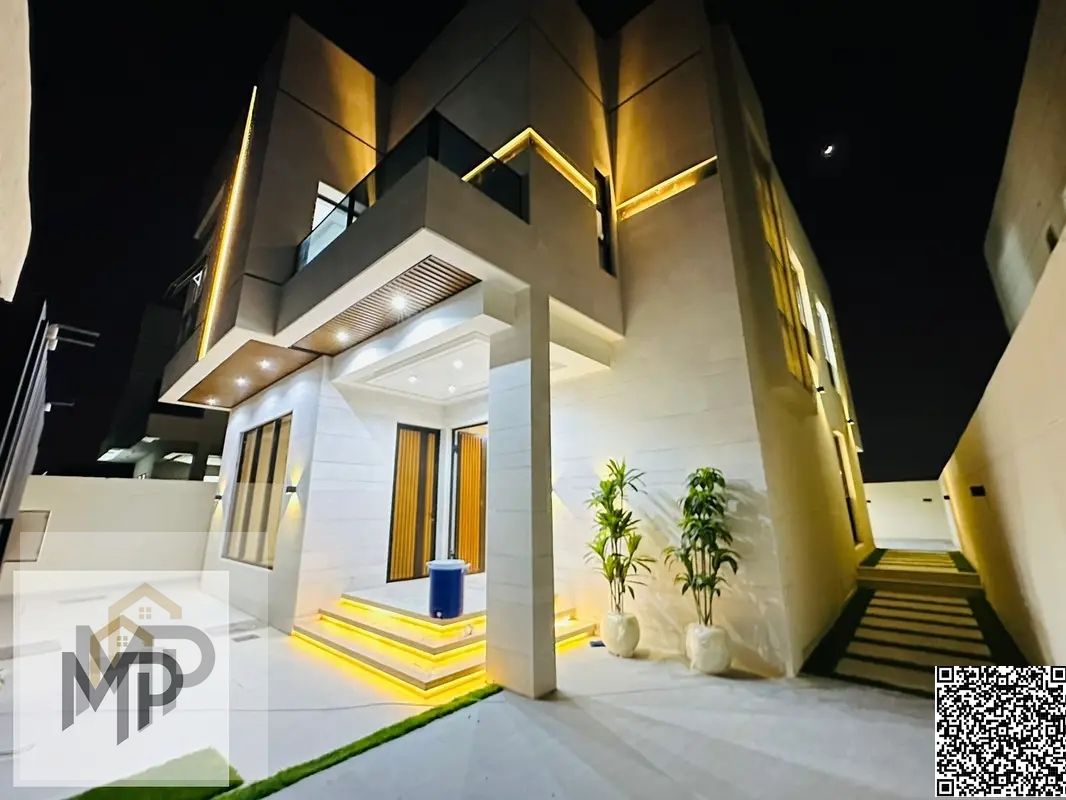 For sale, a modern villa with a stone facade, including registration fees, close to the mosque and services, with a seating area in the courtyard.