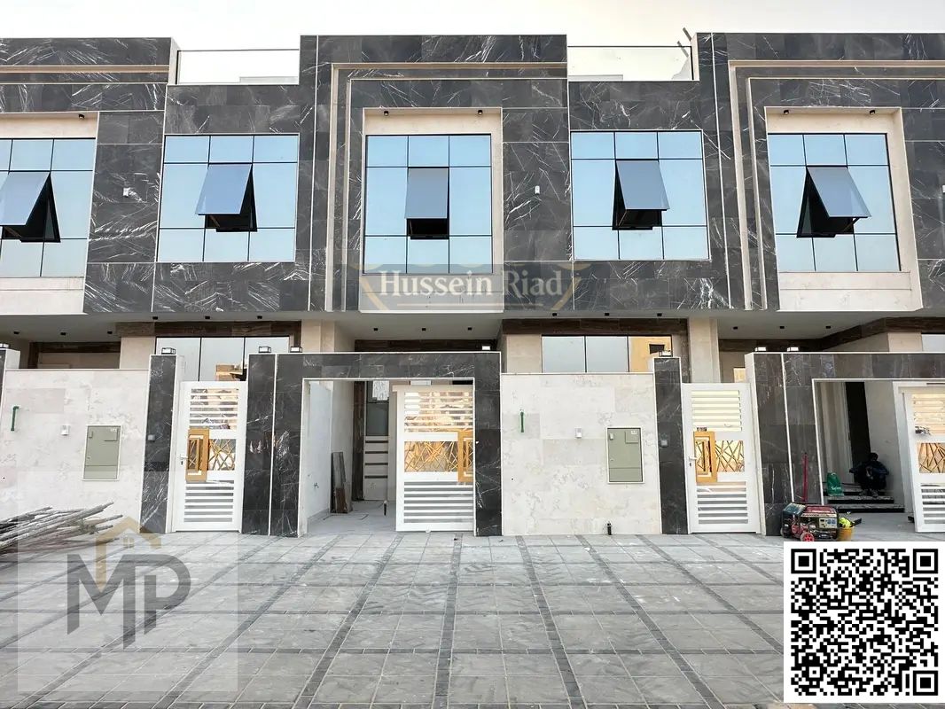 3-story villa with a luxurious stone facade in Al Helio 2, Ajman, registration fees included.