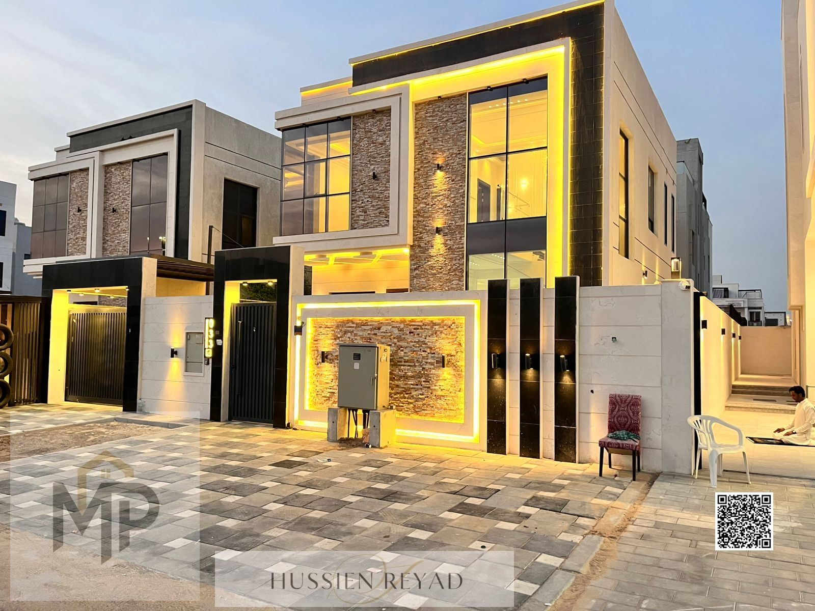 An elegant villa for sale with two floors and a spacious yard, near Sheikh Mohammed bin Zayed Road, with freehold ownership for all nationalities for