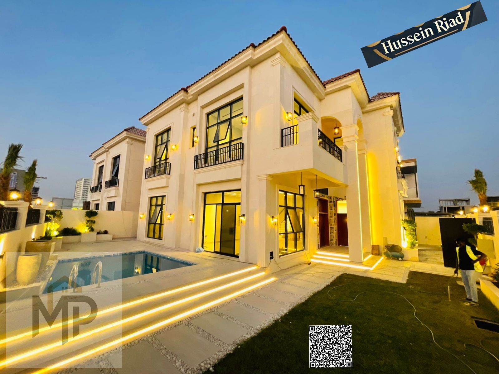 A luxury villa in **Al Yasmine** with a pool and a view of **Al Hamidiya Park**, ready for immediate occupancy and includes air conditioning, water an