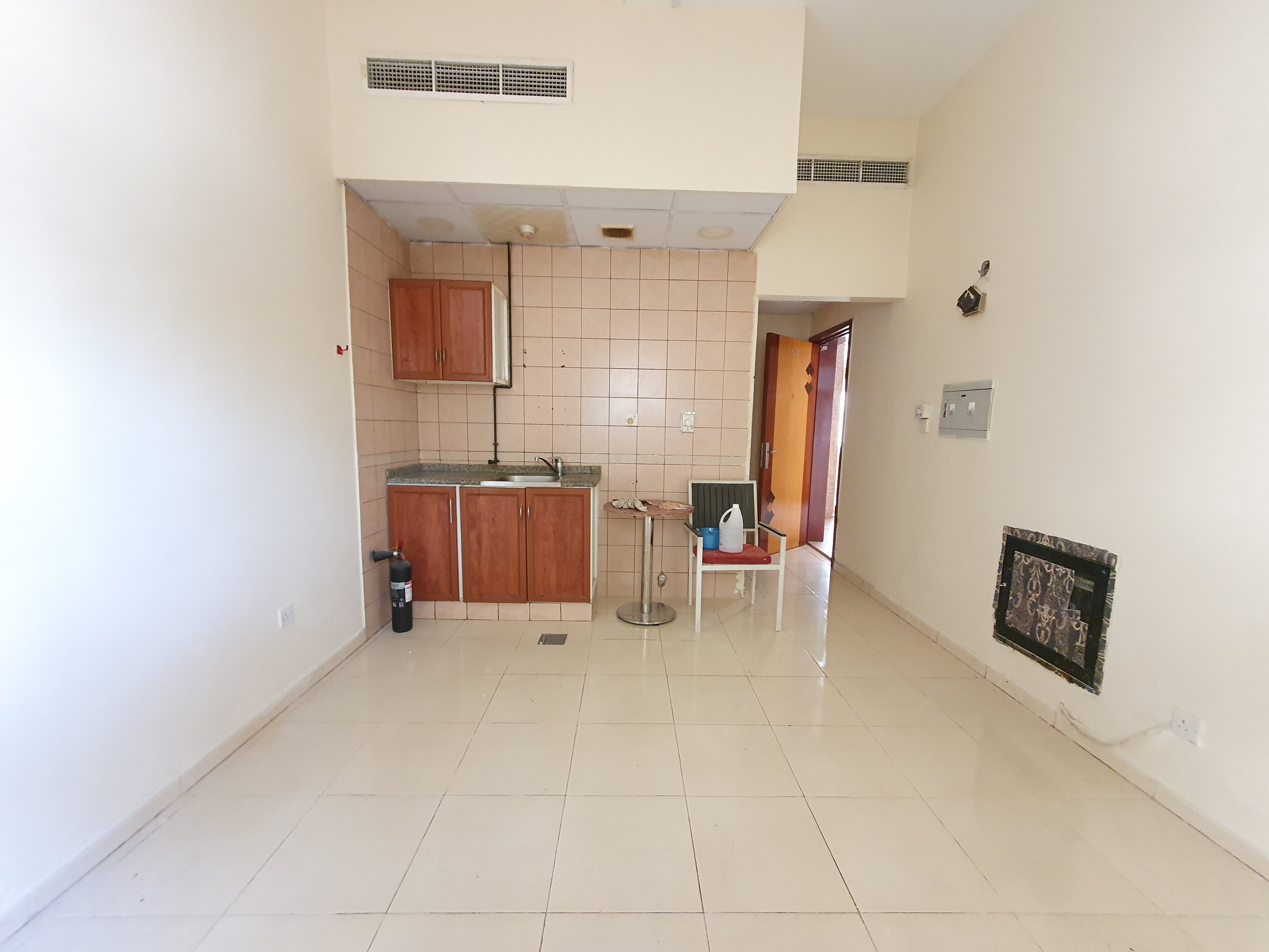 READY TO MOVE STUDIO ON ROAD BUILDING WITH CENTRAL AC IN MUWAILEH