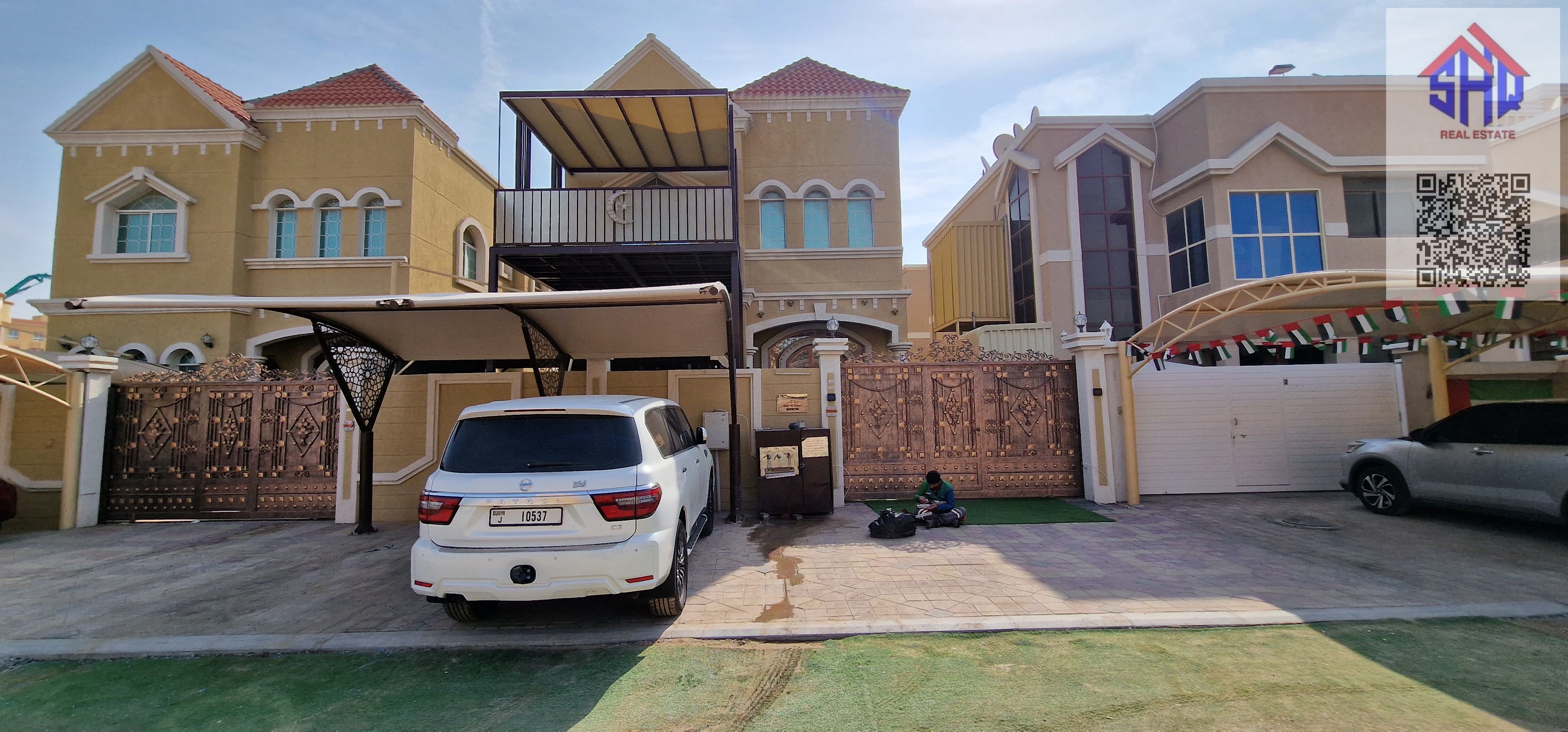 Villa for sale in Al Muwaihat, residential/commercial, fully furnished, with water, electricity, and air conditioning. Five rooms, living room, maid's room, and children's garden.