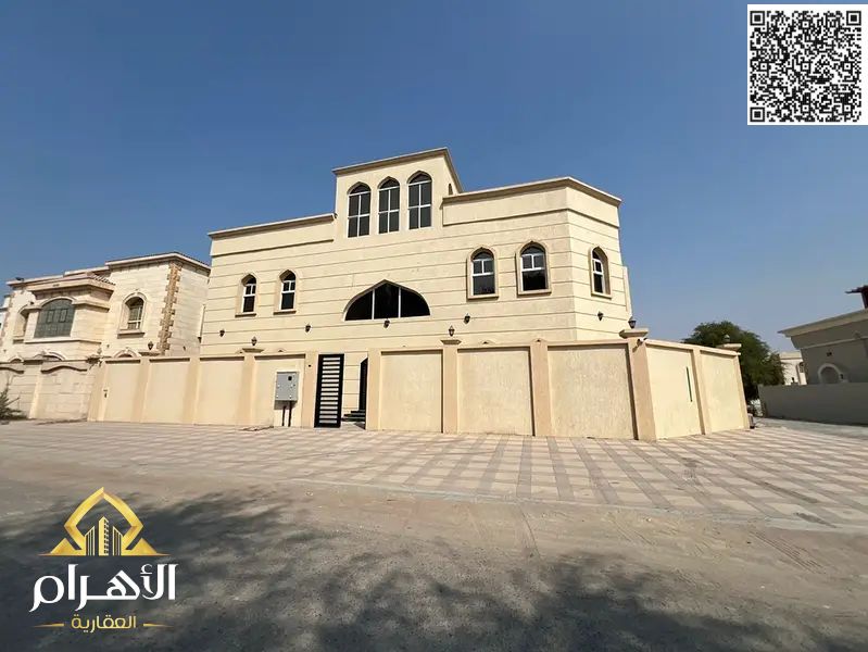 Luxury New Villa for Sale in Al Muwaihat 3 – Corner of Two Streets, Consisting of 12 Master Bedrooms + Four Living Rooms + 4 Kitchens and a Maid's Roo