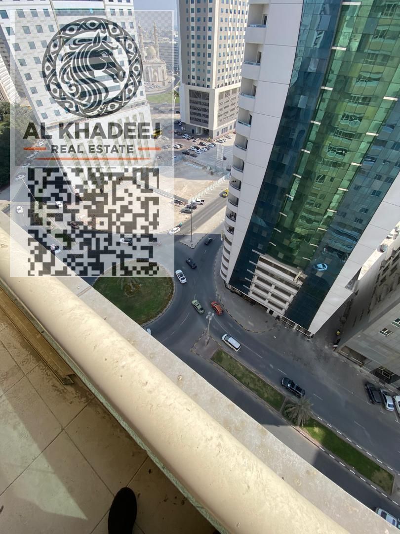 Two bedrooms, a living room, and a balcony with an open view. Arabic ownership only. High floor in Al Taawun area, Sharjah.