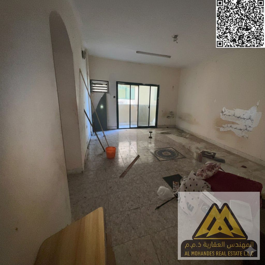 Two bedrooms, a living room, and two bathrooms. Very spacious. | No air conditioning. | Prime location near all services in Al Rashidiya 1.