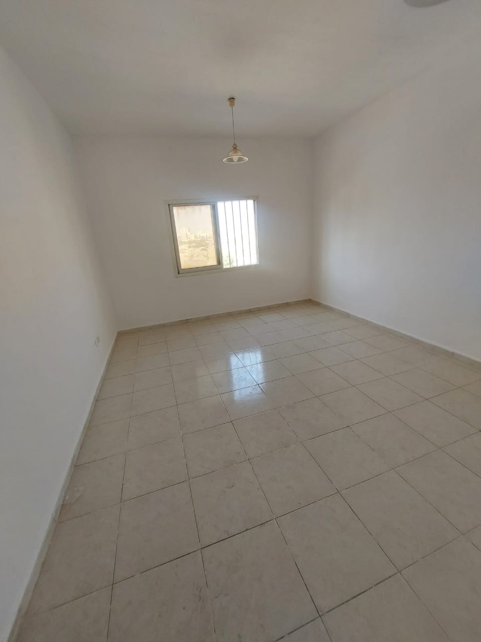Annual Rent in Ajman One-bedroom apartment with living room, kitchen, bathroom, and balcony. Central air conditioning. Location: Al Rashidi