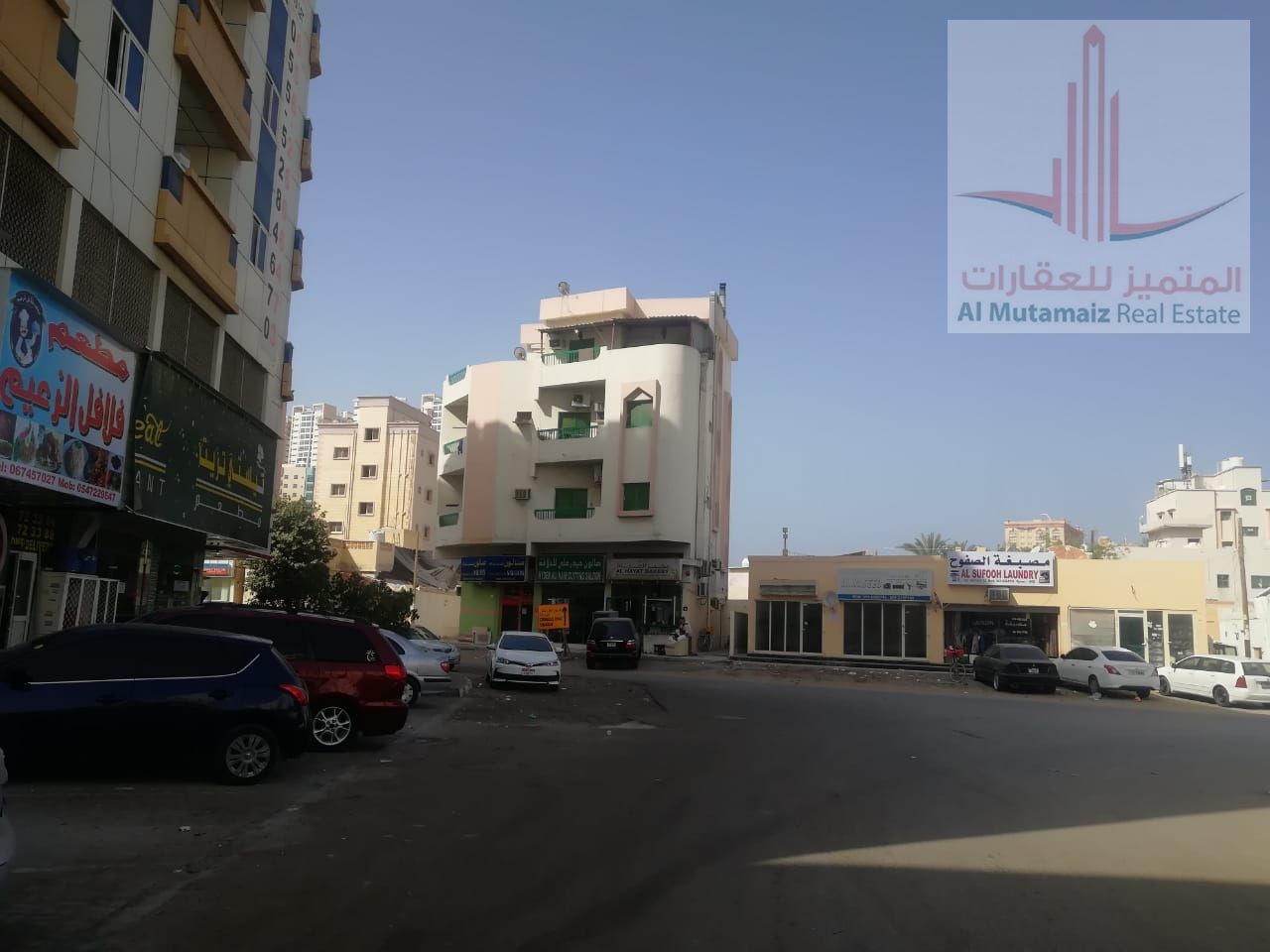 A prime real estate opportunity: commercial land for sale on a corner lot with three main streets in Al Rashidiya, Ajman.