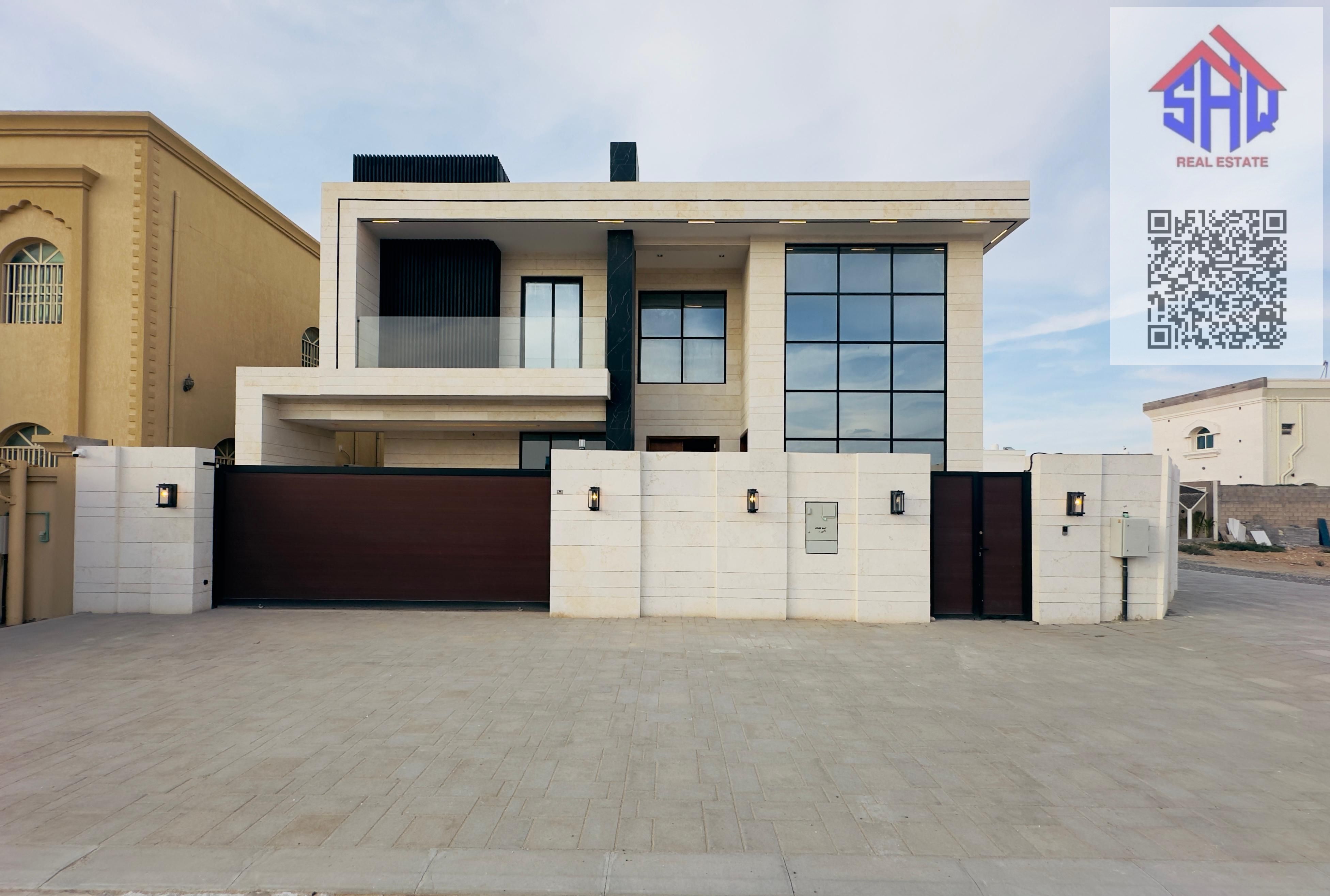 Villa for sale in Al Rawda, including water and electricity, split air conditioners, five bedrooms with a TV in each room, a majlis, two living rooms, a fully equipped kitchen, a maid's room, and a driver's room.