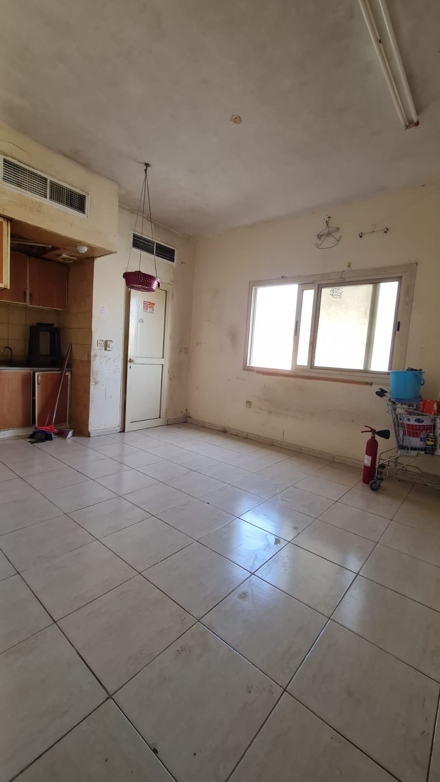 Family studio with central AC in Al Butina, Sharjah, suitable for a small family, near shopping centers and amenities.