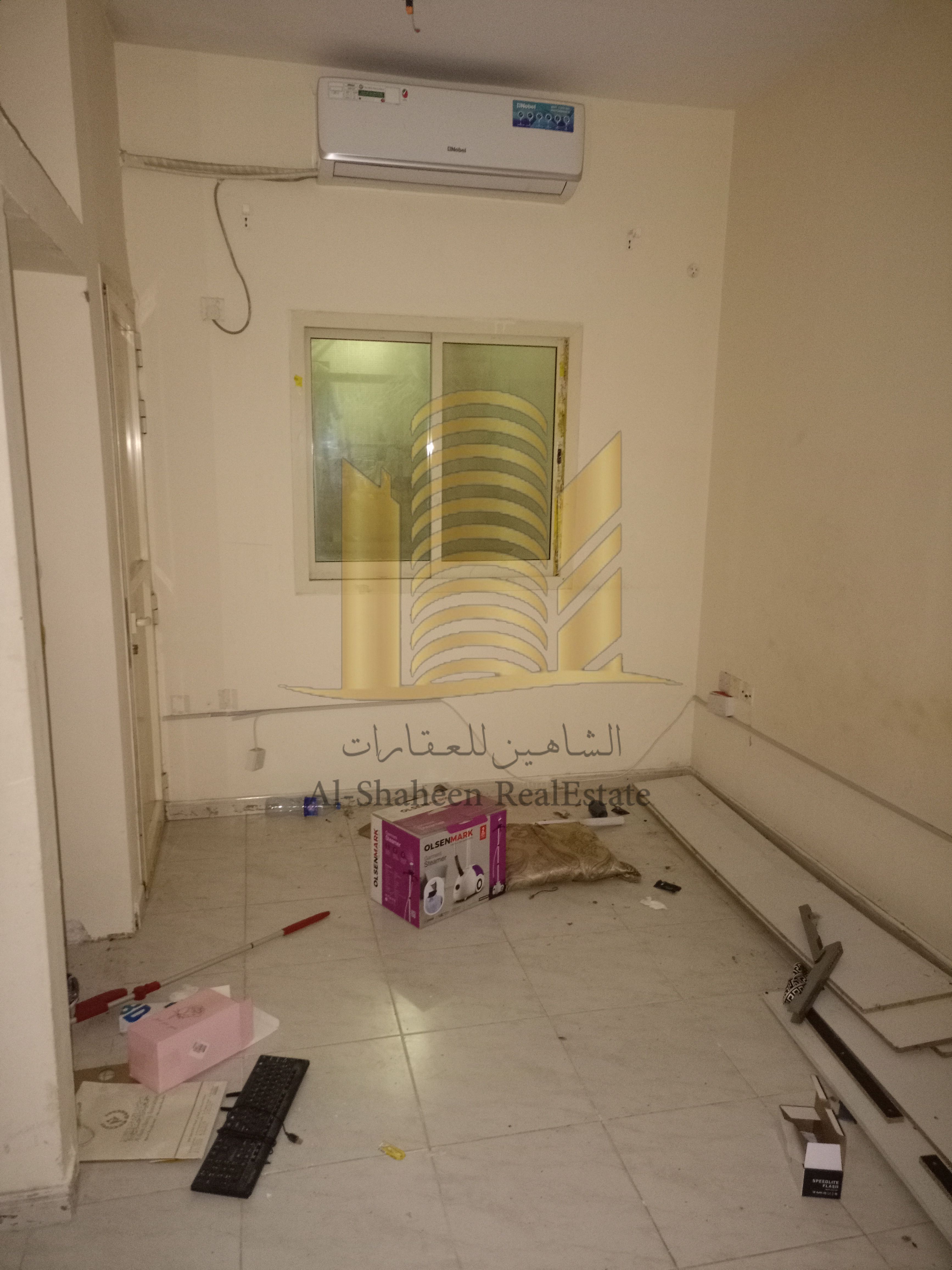 Studio apartment for annual rent in Al Bustan, Ajman, with a separate kitchen and balcony.