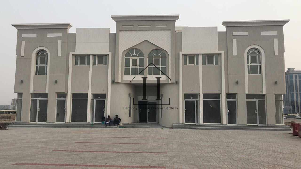 Full Commercial building l Many Units l Glass Ground Floor Storefronts l Huge Parking Area l Main Road Visibility l