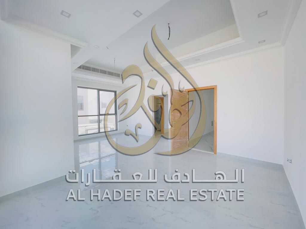 Luxury modern villa for rent in Hoshi area, Sharjah, 5,500 sqft, two floors, private garden, waterfall feature, parking for two cars, central AC and g
