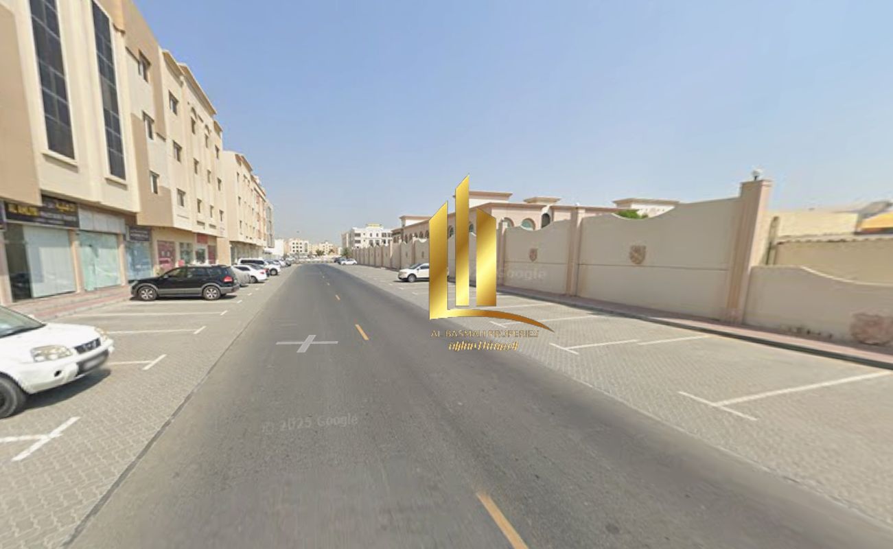 Land for sale in Sharjah, Muwaileh Commercial Area, near schools on an asphalt road.