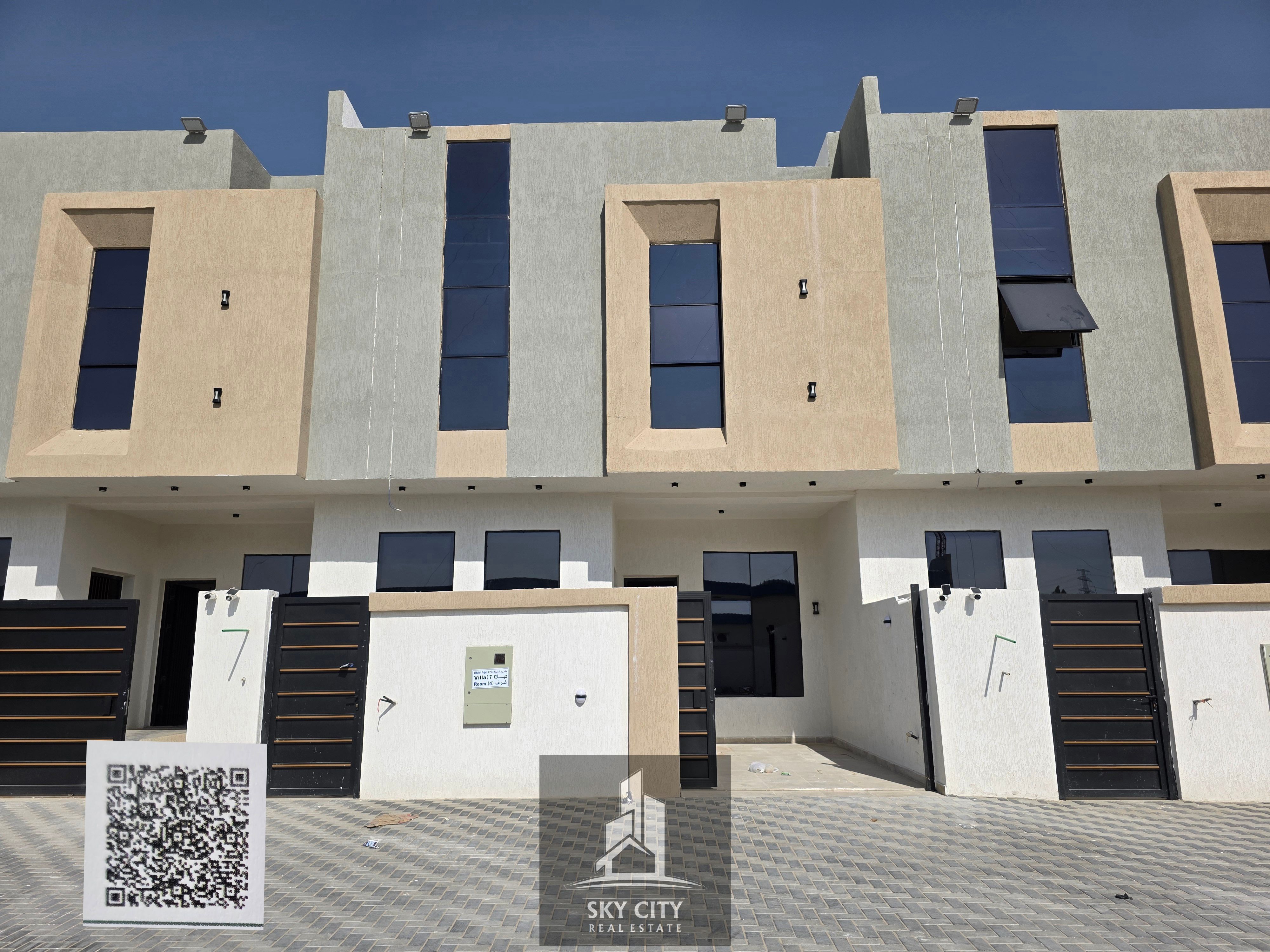 Al-Haliyo, Ajman, behind Emirates Towers on Sheikh Mohammed Bin Zayed Road. Ground floor, first floor, and roof. 4 master bedrooms, majlis, living room, maid's room, large setback in front of the villa. Includes registration and ownership fees. Freehold o