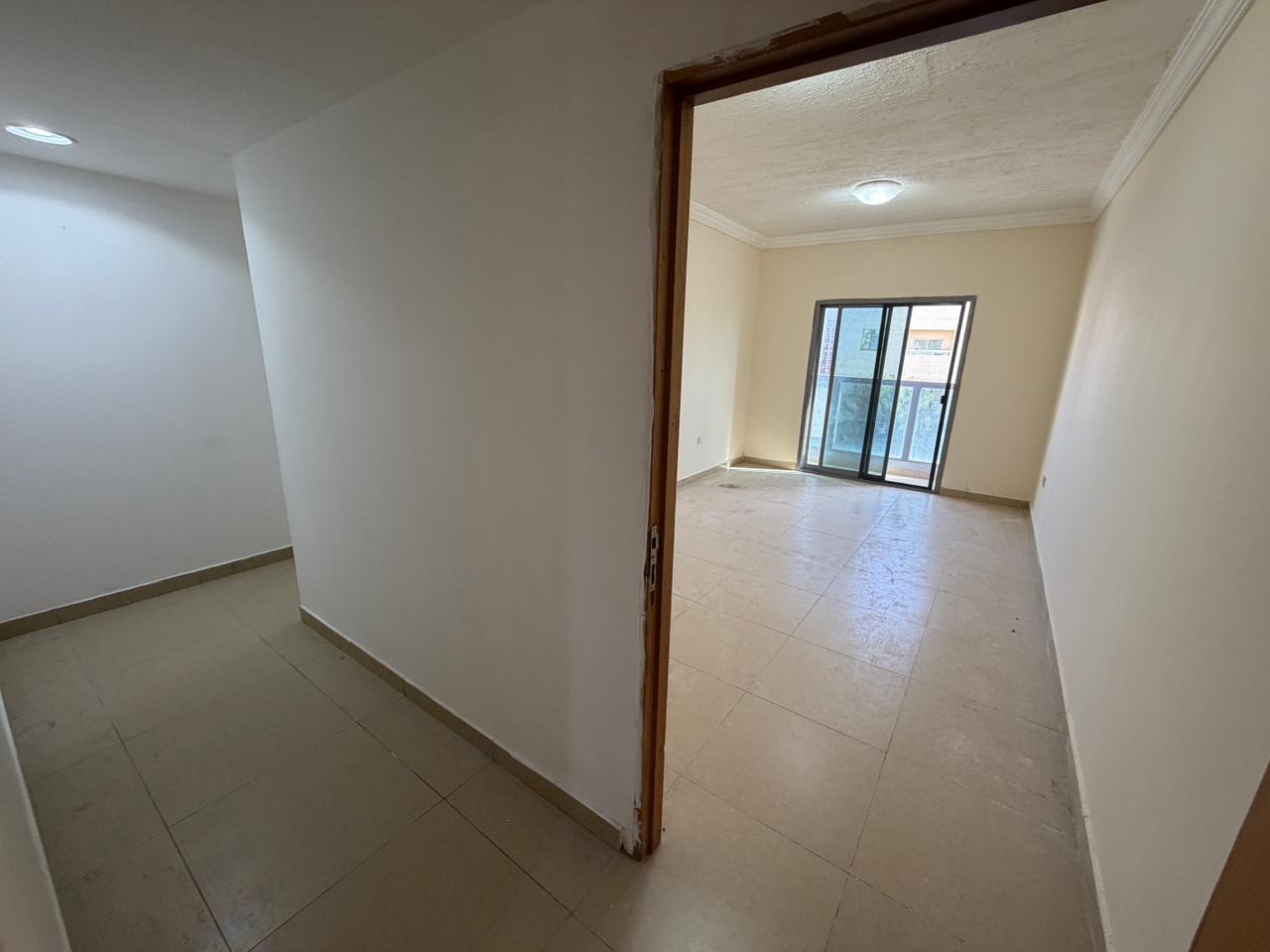 A two-bedroom apartment with a living room is available for annual rent in Al Muwaihat, Ajman
