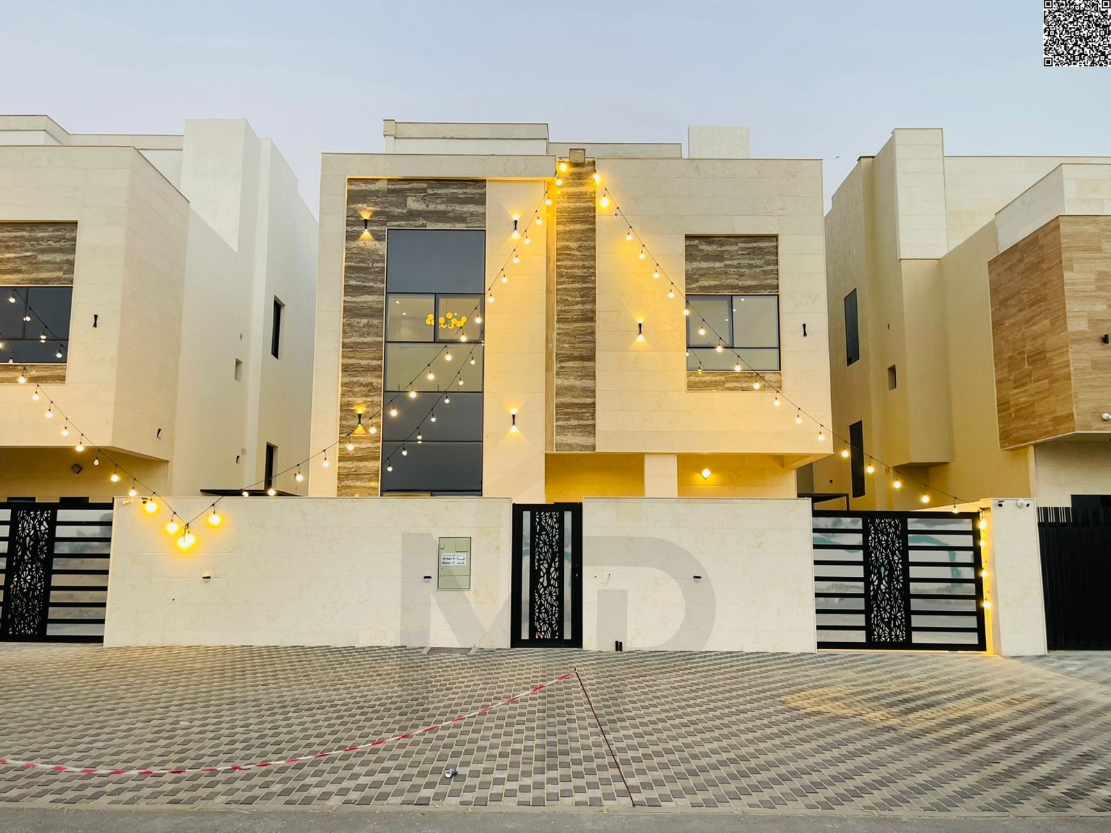 A luxurious two-story villa with a rooftop terrace, featuring a modern design, 7 master bedrooms, an elegant majlis, a spacious living room, a maid's