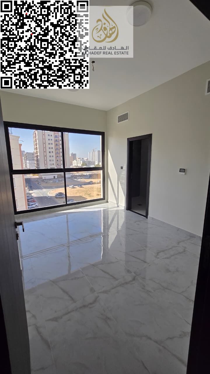 Two bedrooms, a living room, three bathrooms, and a balcony. First occupancy, super deluxe finishing. In Al Jurf 3, on a main street, close to the Chi
