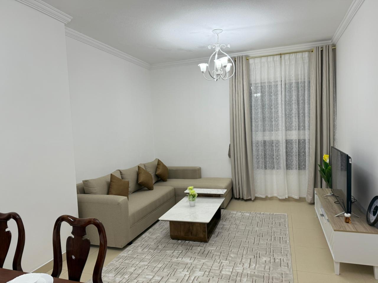 Furnished two-bedroom apartment with a living room for monthly rent in Ajman. Second tenant. Large area, two bathrooms (one master bedroom), and a ve