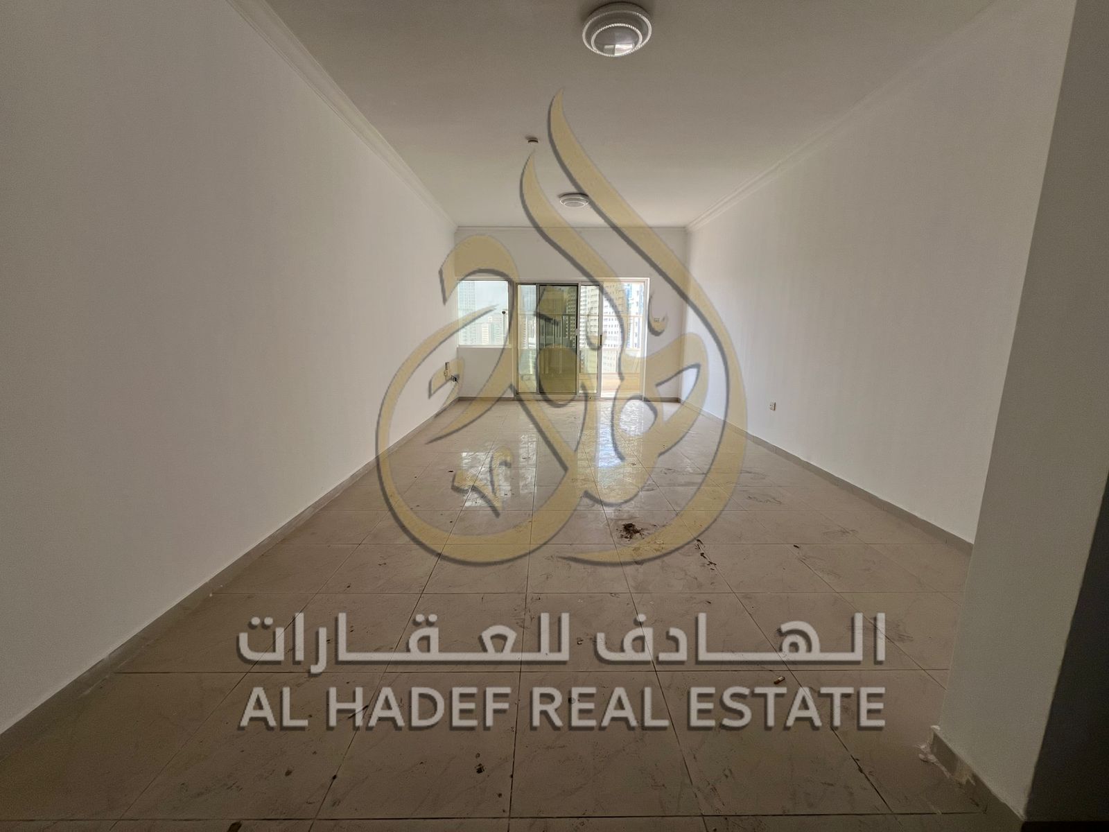 For rent in Sharjah - Al Qasba, a three-bedroom apartment with a living room and free parking inside the tower + one month free.