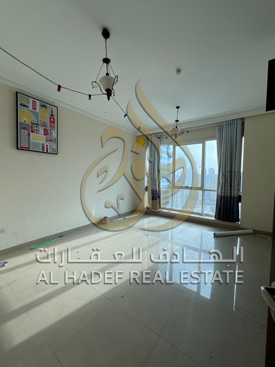 For rent in Sharjah - Al Majaz 3, a two-bedroom apartment with a living room, free air conditioning, parking, a maid's room, and a hallway with an ope