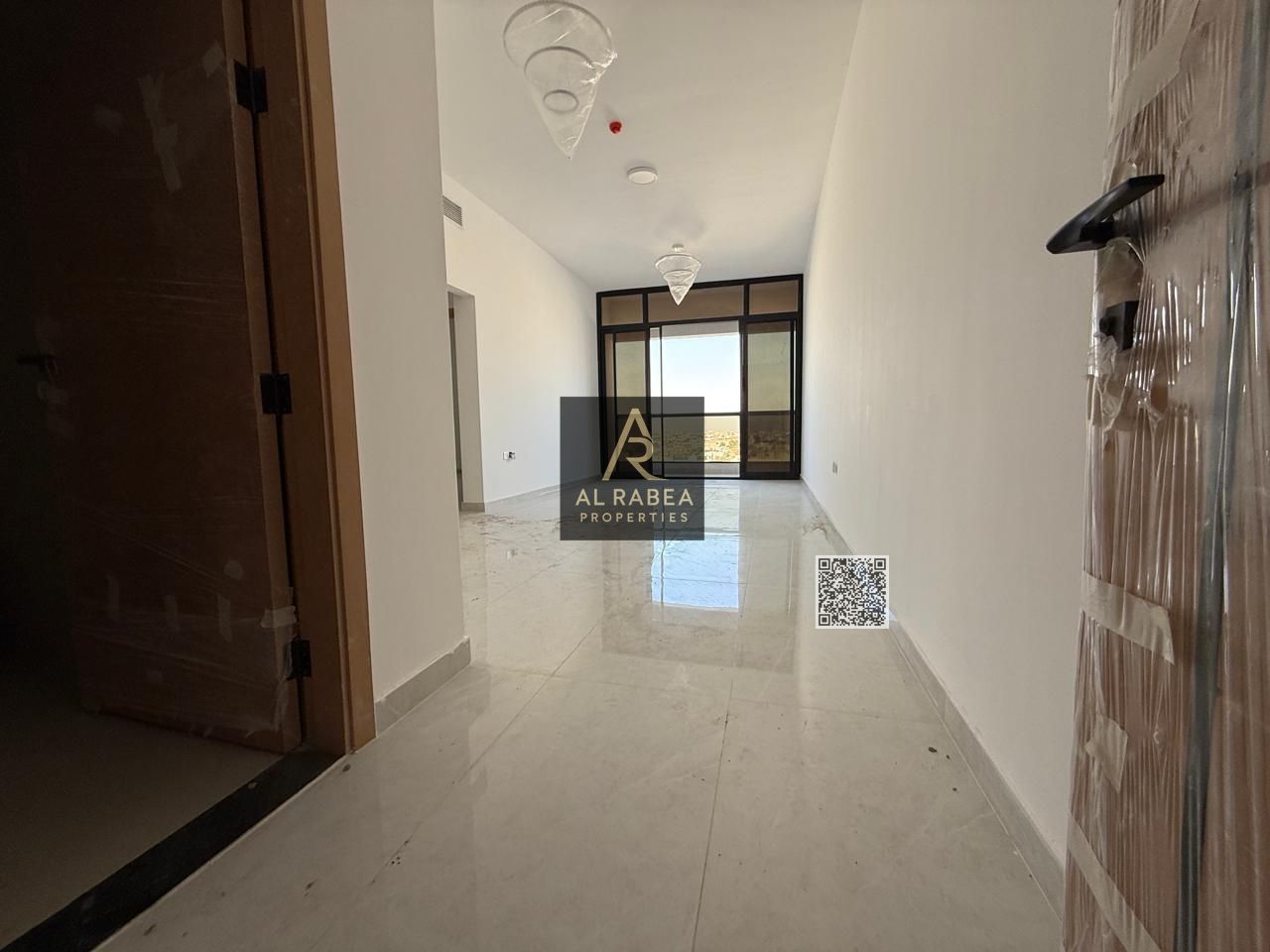 **English Translation:** Annual Apartment for Rent in a New Building in Al Jurf 2 A distinctive apartment available for annual rent in a large, bran