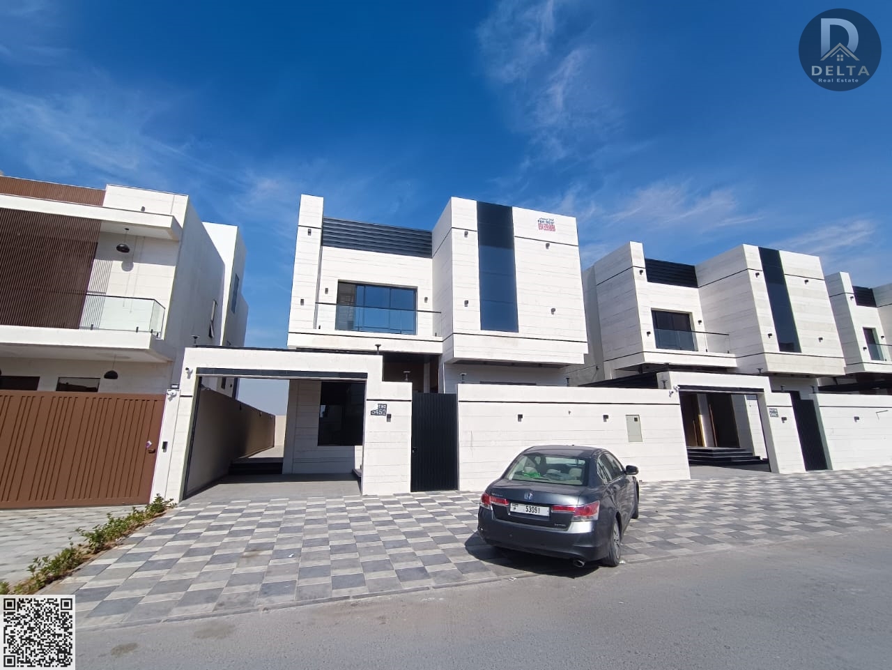 A modern villa for rent with a white stone facade and glass windows, located in one of Ajman's most prestigious areas, Al Helio 2. The villa features